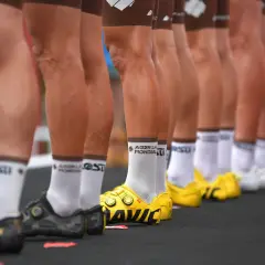 Reihen von Rennrad-Beinen in Radhosen und Socken, bereit für das Rennen.